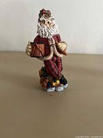 Front view of 6" resin Santa figurine holding drum