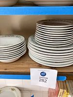Stacks of floral dinner plates and bowls on shelf