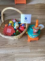 Overall lot with basket of toys and Playskool spinner