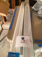 Six long tube bulbs, four in LED replacement packaging and two standard fluorescent tubes