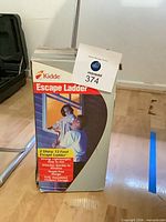 Boxed Kidde 13-foot 2-story escape ladder standing upright