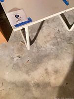 table top corner with lot sticker and white laminate surface