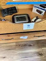 Drawer containing boxed Timex LED clock, LCD digital clock, power adapters
