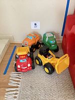 Group shot of all four plastic trucks