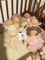 Group shot of all dolls on bed frame for overview