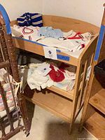 Full view of wooden changing table with top rail and lower shelf