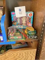 Shelf view showing Doc McStuffins kit, crayons, craft bag on left