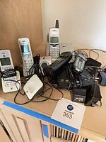 Overall view showing assorted cordless handsets, bases and adapters