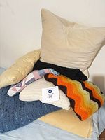 Pile showing pillows and various blankets