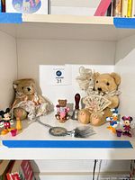 overall lot on shelf showing bears, Disney figures, bell, cord tassel, cups