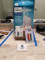 Overall lot showing Philips Sonicare box, brush head box, bath crayons