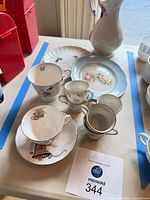 Group shot of all teacups, saucers, plates and vase