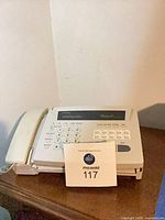 Top view of fax machine showing handset, keypad and display