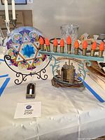 Star of David glass panel, electric menorah, and yahrzeit light displayed on table