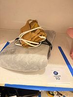 Stacked view of grey and tan heating pads with cords