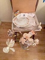 Ceramic Chanukkah bowl on matching plate with artificial flowers and vase visible