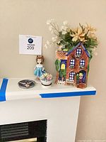 Shows all four items: ceramic house vase with flowers, porcelain girl figurine, floral trinket box, star ring dish