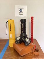 Group view of all flashlights, binocular case and headlamps