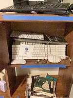 All keyboards, mice, and power strip cover stacked on shelving