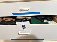 Drawer showing mixed winter accessories with label 44