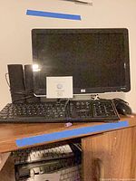 Full view of HP monitor with keyboard, speakers and mouse