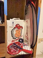 Overall shot showing hamper, rally monkey bag, poster, seat cushions and fan clappers