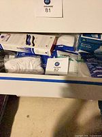 Drawer containing various sealed mask packs and glove box