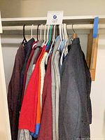 Closet rod with multiple men’s garments on hangers