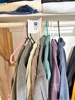 Group of men’s garments on hangers showing colours and styles