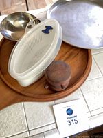 All five items grouped: wood tray, pepper mill, pizza pan, stainless bowl, salad keeper