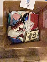 Box top view showing assorted kippot and two books