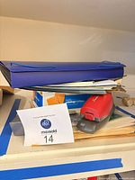 Full lot showing purple accordion file, stapler, folders