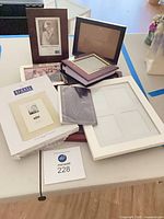 Overview of assorted frames and album on table