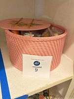pink woven sewing basket with lot label