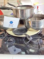 Group view of saucepans, fry pan and nested mixing bowls