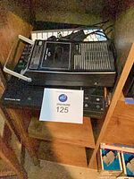Stacked view of cassette player, Apple keyboard, and Epson scanner