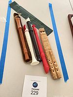 Five recorders laid out with cases visible