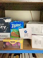 Shelf showing Ziploc bags, straw box, Peeps candy and lot tag