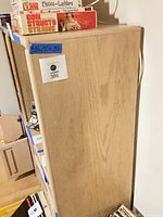 Side perspective of entertainment center showing height and depth with taped dimensions