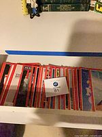 Drawer containing stack of Time magazines, lot ticket visible