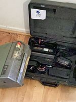 Wollensak recorder beside open Hitachi camcorder case showing contents