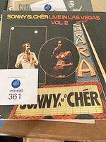Front cover of Sonny & Cher LP with lot tag and other records below