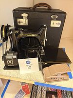 Full view of Singer sewing machine with motor, foot pedal and carrying case