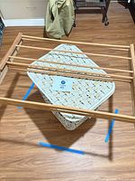 Laundry hamper topped by drying rack, overall view