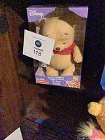 Front view of boxed Winnie the Pooh plush showing Disney branding and product line