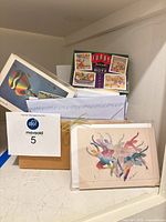 Overview of box containing assorted note cards, boxed sets and envelopes