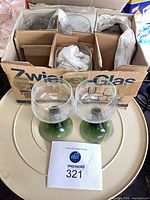 Closed box labeled Zwiesel Glas with two glasses displayed in front