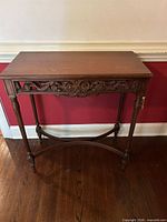 Front view of carved solid wood console table