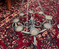 Top view of entire chandelier showing eight candle cups and suspension chains