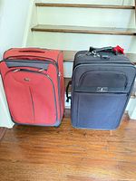 Red and black soft-shell suitcases side by side